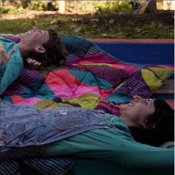 Women laying on Chromatic Voyage eco-friendly, recycled puffy blanket