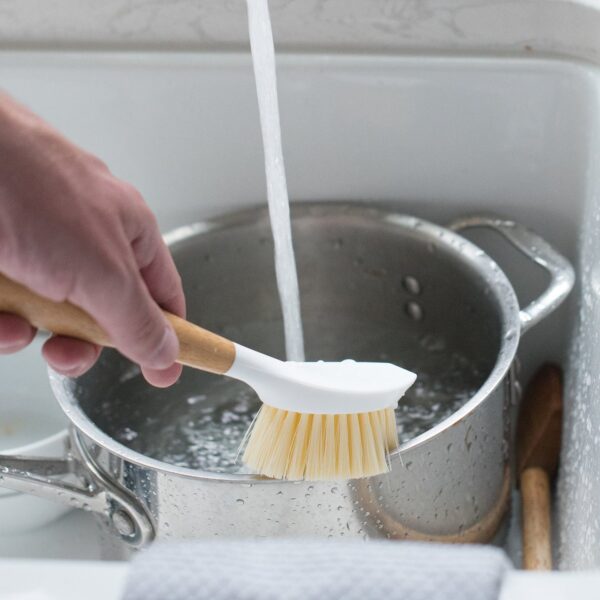 Eco friendly recycled plastic and bamboo dish cleaning brush from Full Circle cleaning a pot