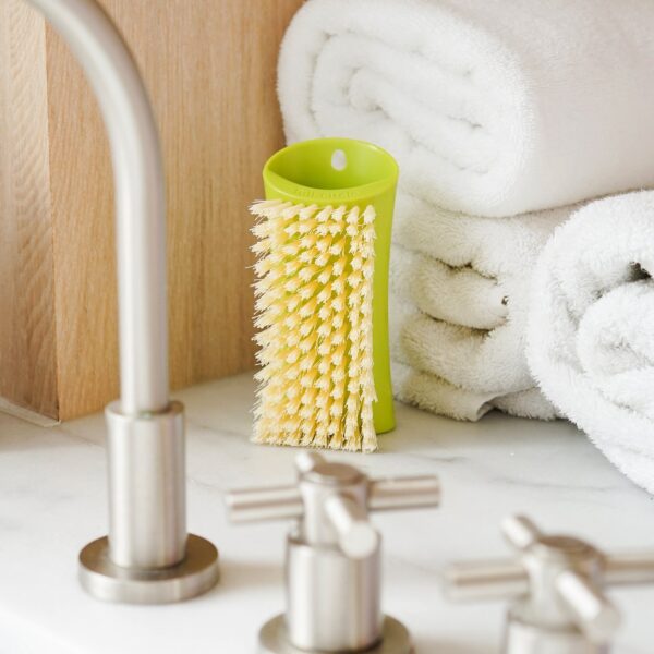 Green, recycled plastic scrub brush from Full Circle at a sink