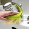 Green, recycled plastic scrub brush from Full Circle at a sink