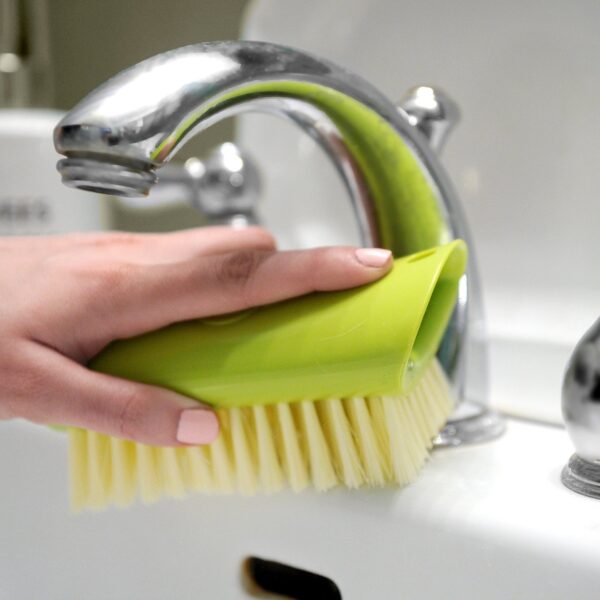 Green, recycled plastic scrub brush from Full Circle at a sink