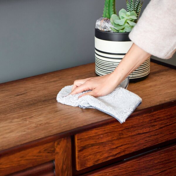 Eco-friendly white recycled microfiber dust cloth on a wood console from Full Circle Home