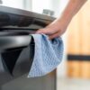 Blue recycled microfiber cleaning cloth from Full Circle Home on a stove railing