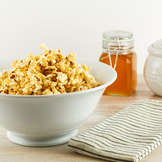 Bowl of sweet and spicy honey popcorn for National Honey Month recipes
