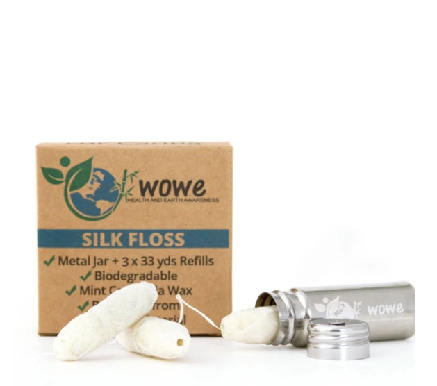 Wowe Lifestyle natural floss is made from 100% biodegradable, sustainably sourced silk. Photo shows plain brown box, stainless steel floss dispenser, and the 3 floss refills included.