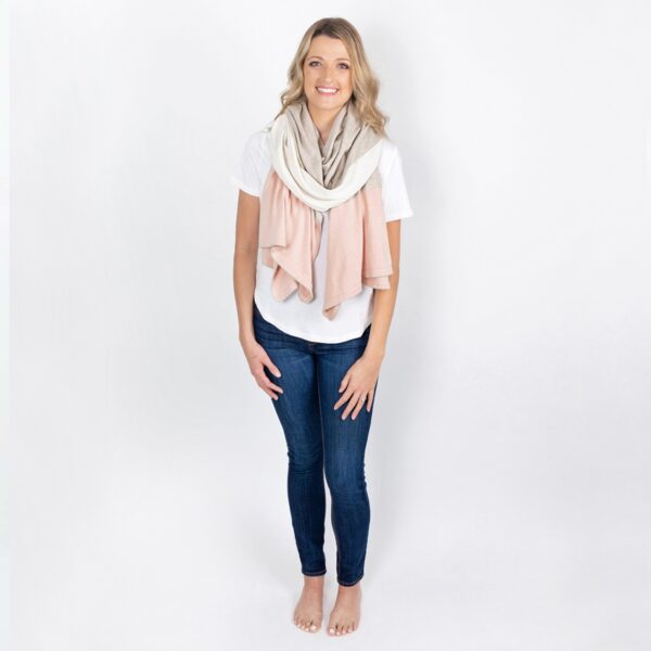 Model is shown wearing the Zestt Organics travel scarf in blush color block, made from 100% organic cotton.
