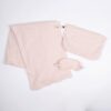 The Organic Cotton Travel Set by Zestt Organics, shown in pink or blush, comes with a knit throw, eye mask, and carrying pouch.