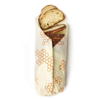 The eco-friendly Bee's Wrap brand honeycomb printed bread wrap is shown here, cut larger to accommodate a full loaf of bread.