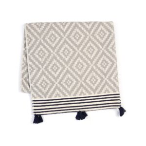 This Hilana Merida Gray Turkish Towel is made from 50% recycled cotton and has a beautiful Mexican inspired gray, white, and black pattern.
