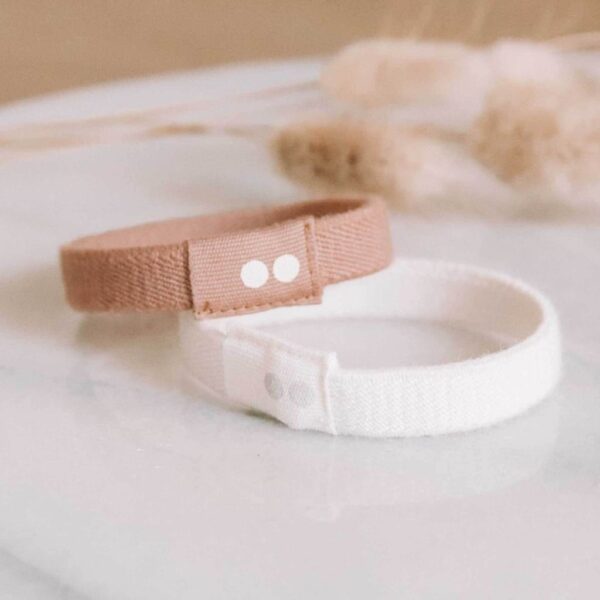 The all natural, fully biodegradable Kooshoo hair ties shown in pink and white, made from organic cotton and fair trade natural rubber.