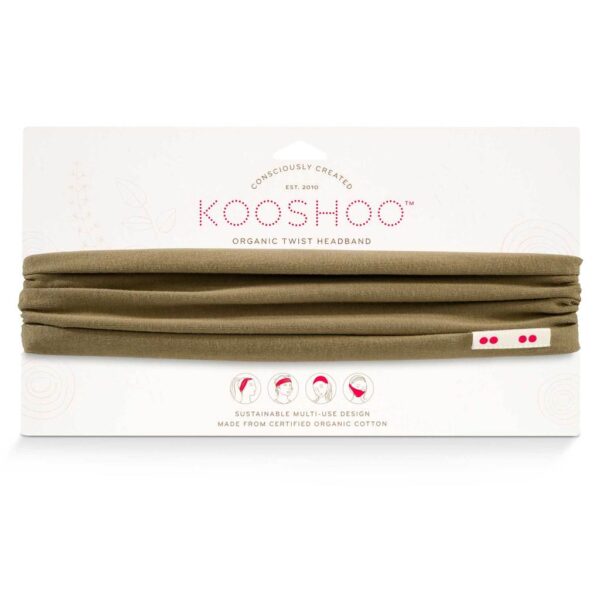 A safari green Kooshoo brand twist headband, made with organic cotton, is shown on display with its FSC certified compostable paper packaging.