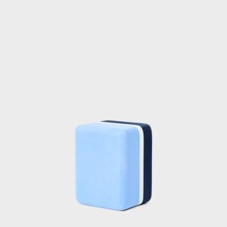 This mini yoga block by Manduka is travel sized and tri-colored, shown here in sky blue, white, and navy. Made from more than fifty percent recycled EVA foam.