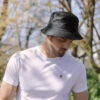 Male wearing black organic cotton bucket hat from tentree