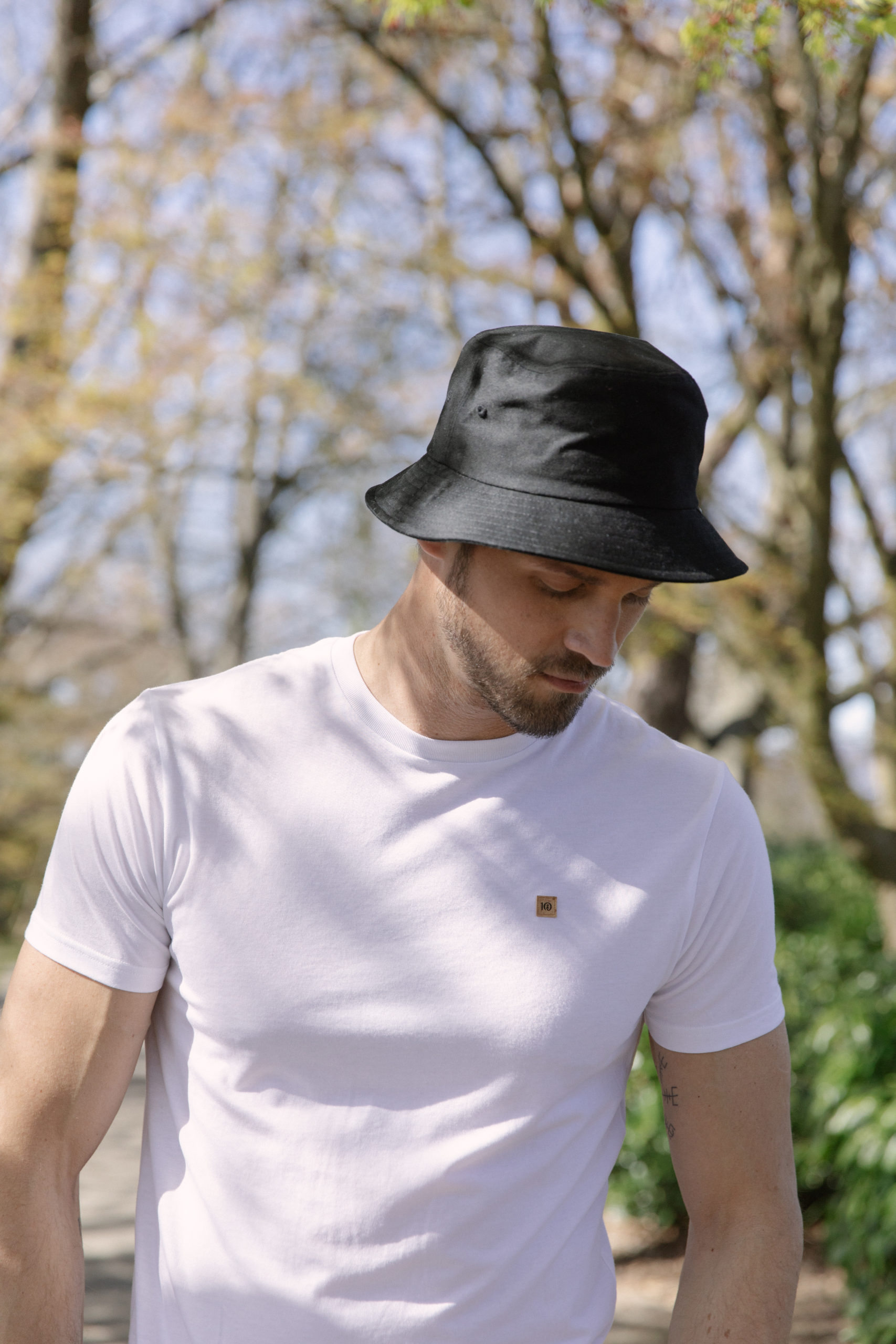 TENTREE-BUCKET-HAT-TAU4214-0164_TCM1869-0016_X3A4333 Male wearing black organic cotton bucket hat from tentree