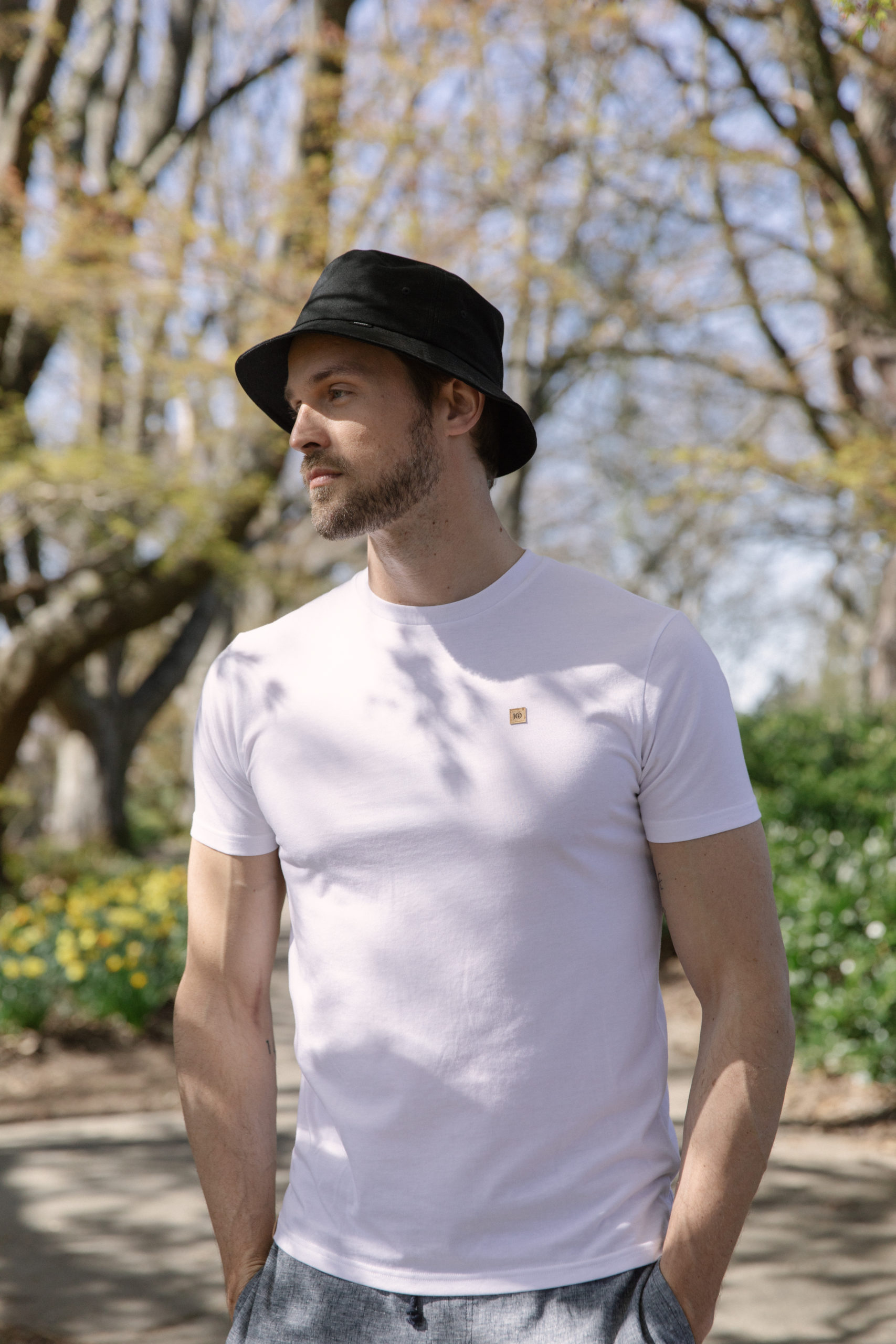 TENTREE-BUCKET-HAT-TAU4214-0164_TCM1869-0016_X3A4338 Male wearing black organic cotton bucket hat from tentree