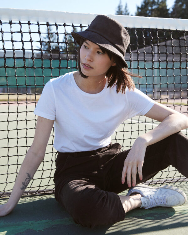 Female wearing black travel bucket hat from tentree