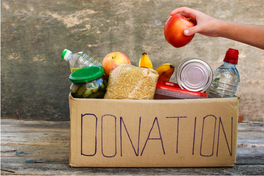 Food going into donation box for low waste Thanksgiving blog