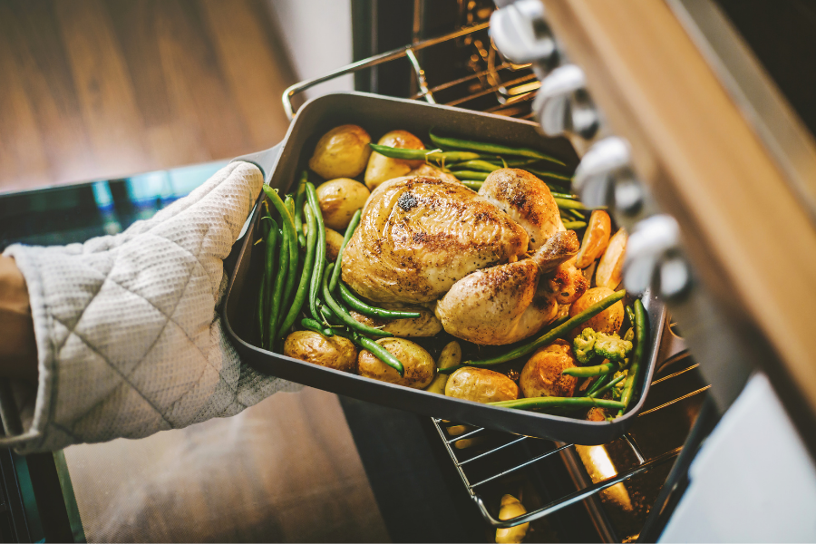 Turkey going into oven for Thanksgiving food waste blog