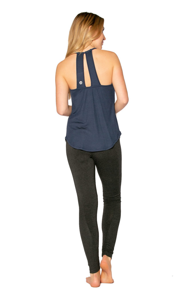 Back view of woman in sustainable navy tank and black leggings gift set