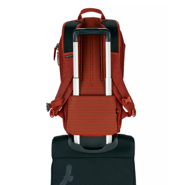 The eco-friendly Explore 26L backpack by Eagle Creek has a trolley sleeve on the back panel which allows you to easily secure the pack on top of any dual-handled wheeled travel bag; shown here in midnight sun red.