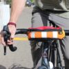 Close up showing that the Hipster hip pack by Green Guru can be attached to the handlebars of a bike, and then can be taken off the bike as needed and worn as a hip pack.