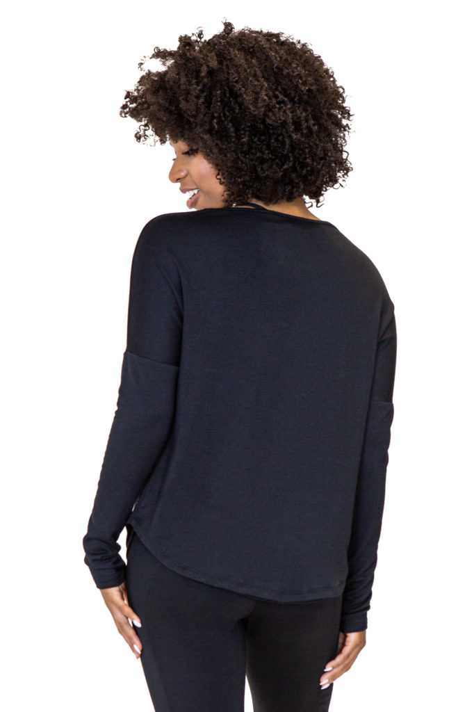 Model is showing the back of a black pullover made from eco-friendly French Terry fabric, by brand JJWinks. Made in USA, this pullover is carbon neutral.