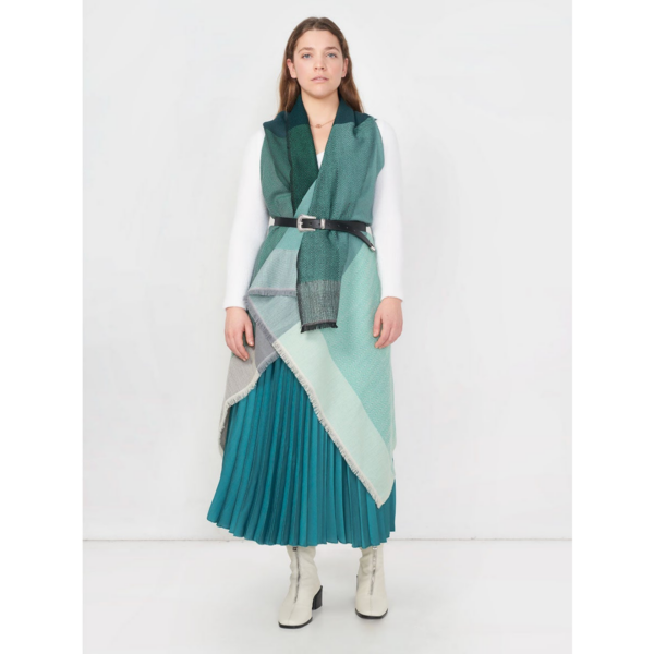 The organic Artisanal Cape Infinity by Fifth Origins is shown here beautifully wrapped and belted on a model wearing a long skirt. Each eco-friendly purchase supports women artisans.