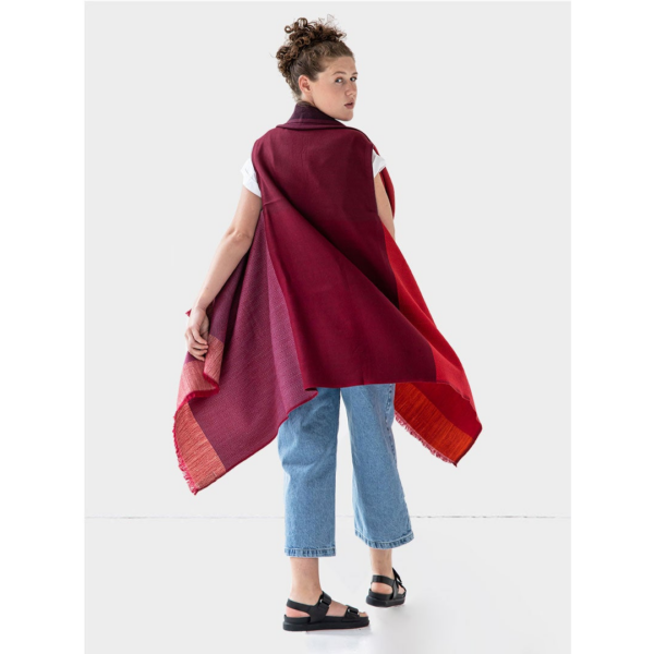 The back of the Artisanal Cape Infinity by Fifth Origins is shown here in color block merlot. It is sustainably made using 100% organic wool.