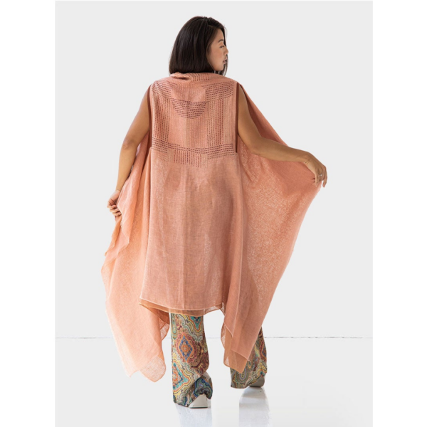 The back of the Artisanal Cape Infinity Duo by Fifth Origins is hand embroidered with an exquisite pattern created by rural Indian artisans. Made with eco-friendly organic linen, shown in shades of pink and orange.