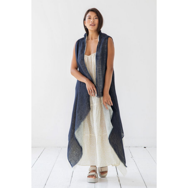 This light and flowy cape is made from eco-friendly organic linen, and supports rural women artisans. Shown here in reversible blue and white.
