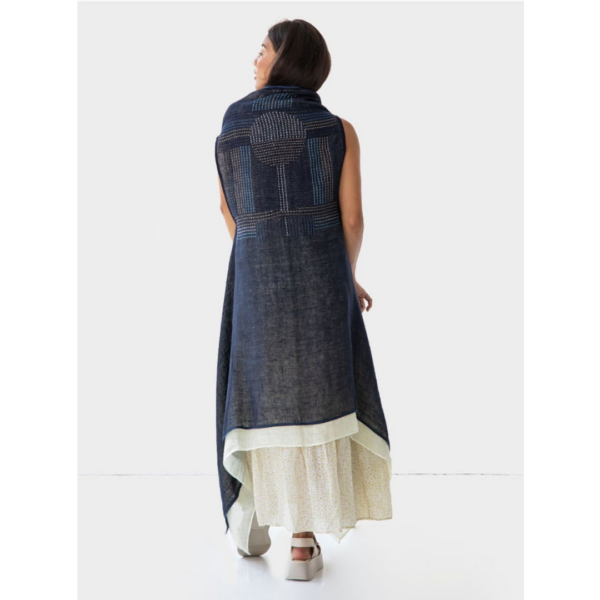 The back of the Artisanal Cape Infinity Duo by Fifth Origins is hand embroidered with an exquisite pattern created by rural Indian artisans. Shown in blue and white and made with eco-friendly organic linen.