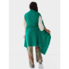 A model is showing off the back of the Cape Infinity Lite by Fifth Origins, shown here in emerald green. Made from eco-friendly organic Himalayan wool, this is the perfect cape to dress up any outfit.