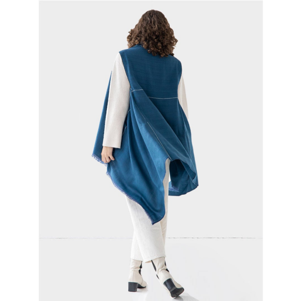 The earth-friendly Artisanal Cape Infinity Lite, modeled here in peacock blue, is made from 100% organic Himalayan wool and is woven by women artisans.