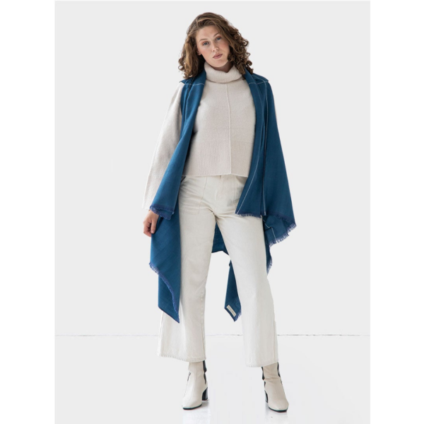 The earth-friendly Artisanal Cape Infinity Lite, modeled here in peacock blue, is made from 100% organic Himalayan wool and is woven by women artisans.