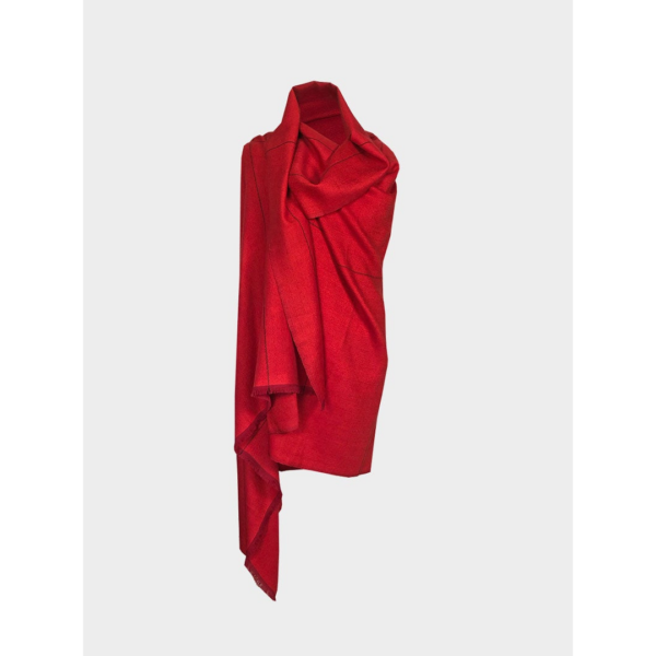 The sustainable Artisanal Cape Infinity Lite, shown here in rose red, is made from 100% organic Himalayan wool and is woven by women artisans.