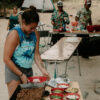 Woman serving food at campground from bamboo foldable travel table