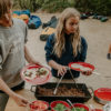 Kids serving food from collapsible, travel and camping bamboo and aluminum table