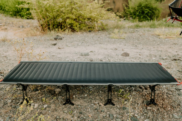 Outdoor view of unfolded travel cot for sustainable camping gear