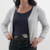 This money belt by Eagle Creek is made from natural silk. Photo shows model wearing money belt and opening zipper to access interior. An earth-friendly travel solution that will keep your belongings safe!