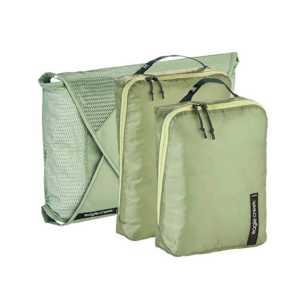 The Pack It Starter Set in Mossy Green, by Eagle Creek, contains one small packing cube, one medium packing cube, and one garment folder. A great starter for ultimate packing and organization.