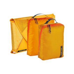 The Pack It Starter Set in Sahara Yellow, by Eagle Creek, contains one small packing cube, one medium packing cube, and one garment folder. A great starter for ultimate packing and organization.