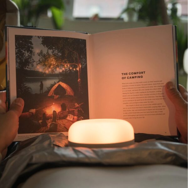 Reading a book by solar powered light and speaker, Explorer from Mpowerd