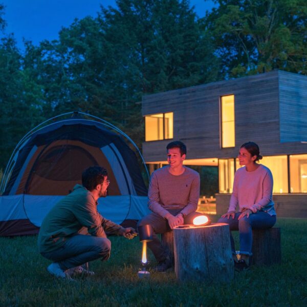 Outdoor camping by tent with solar powered light and speaker