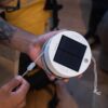 Luci Color Solar String Lights in a hand with carry strap from MPOWERED