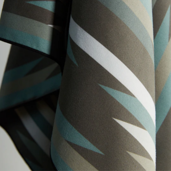 The Ultralight quick dry towel by Nomadix, shown here in close up in Jackson Green, is made from post consumer recycled materials and has a micro suede texture.