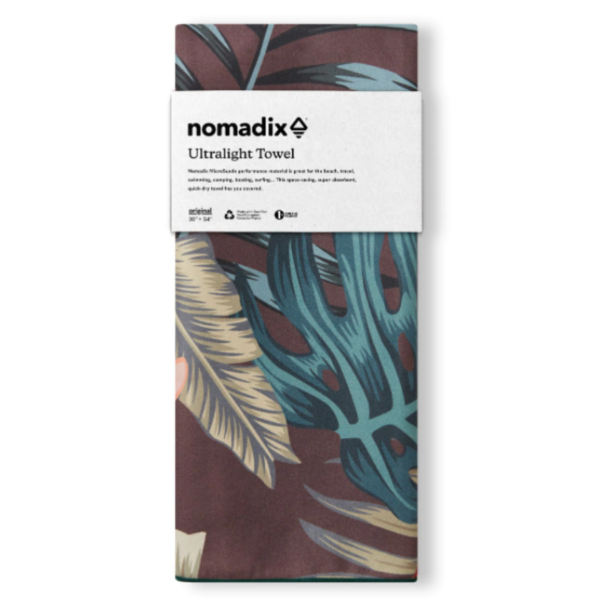 The Ultralight quick dry towel by Nomadix, shown here in Palms Night, is made from post consumer recycled materials and is sustainably made.