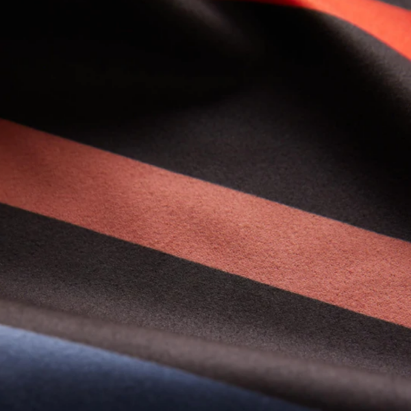 The Ultralight quick dry towel by Nomadix, shown here in close up in Pinstripes Multi, is made from post consumer recycled materials and has a micro suede texture.