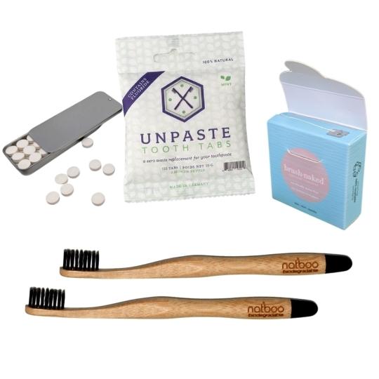 Plastic free dental care set with toothpaste tablets, bamboo toothbrushes and biodegradable dental floss