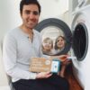 Man and two kids putting in sheet of zero-waste laundry detergent sheet into front load washer