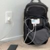The Mobile Pro 3.0 Backpack with Joey is shown here plugged into the wall to charge the attached battery pack. The battery pack can give your phone an extra 25 hours of talk time.